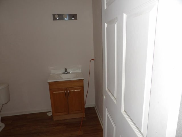 bathroom with vanity, wood-type flooring, and toilet