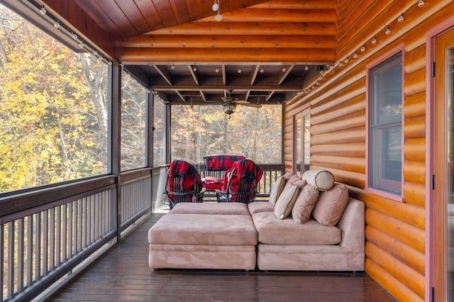 sunroom with vaulted ceiling, ceiling fan, and wood ceiling