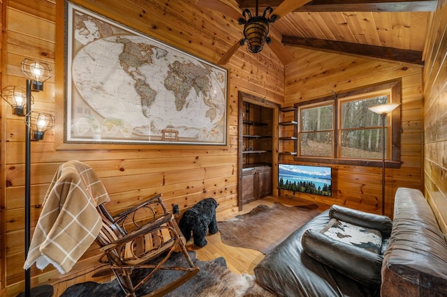 sitting room featuring vaulted ceiling with beams, wooden walls, and hardwood / wood-style floors