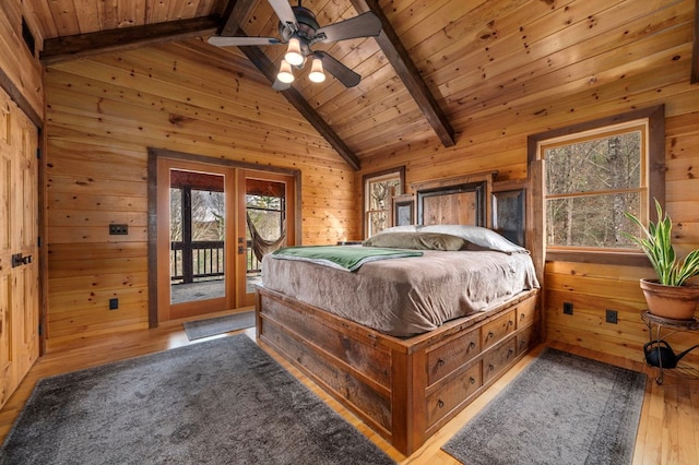 bedroom with access to outside, ceiling fan, wooden walls, wood-type flooring, and lofted ceiling with beams