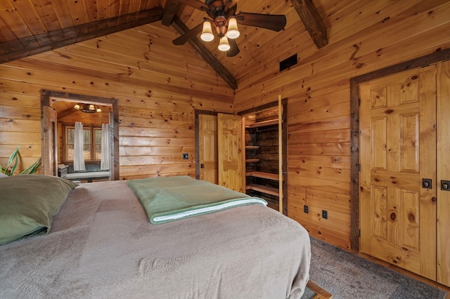 bedroom featuring wood walls, wooden ceiling, lofted ceiling with beams, ceiling fan, and carpet floors