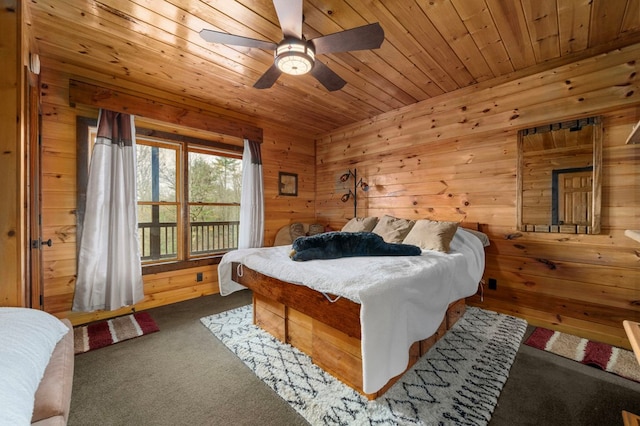 carpeted bedroom featuring wood walls, ceiling fan, and wood ceiling