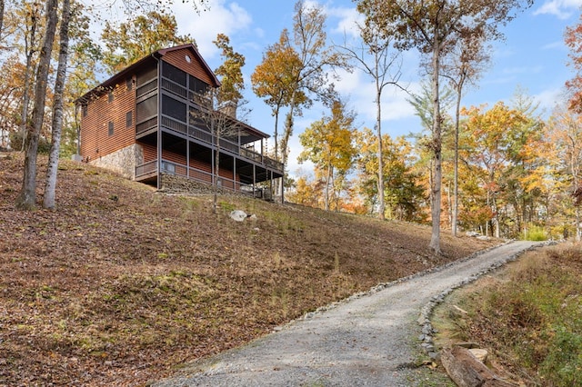 exterior space featuring a sunroom and a wooden deck