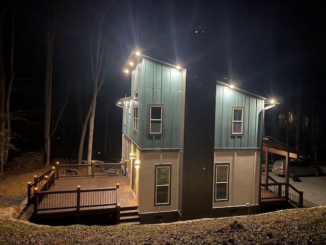 back house at twilight featuring a deck