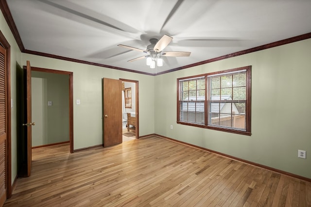 unfurnished bedroom featuring baseboards, ornamental molding, light wood-style flooring, and a closet