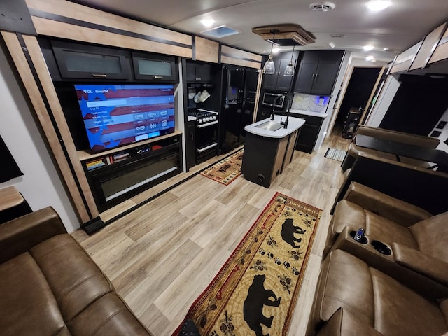 interior space with light wood-style flooring, visible vents, and backsplash