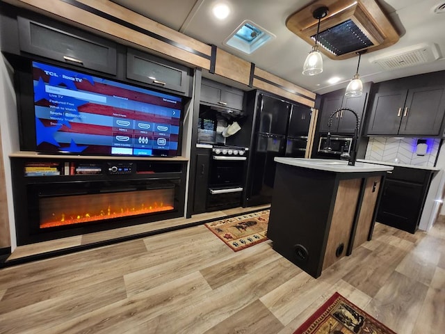 kitchen with backsplash, light wood-type flooring, decorative light fixtures, and a kitchen island