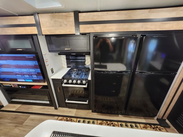 kitchen featuring light hardwood / wood-style flooring and black appliances