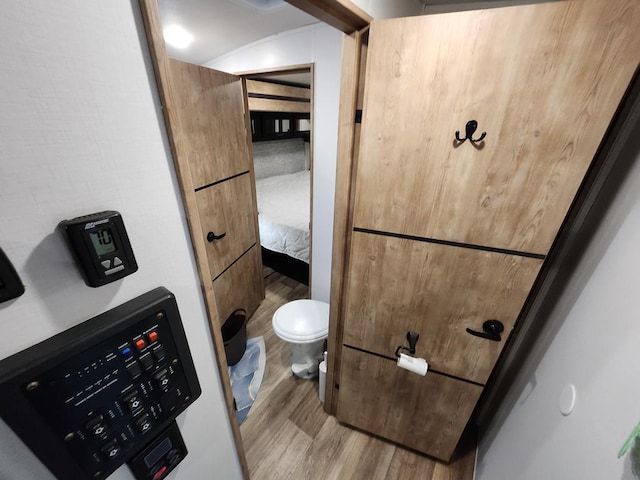 bathroom with wood-type flooring and toilet