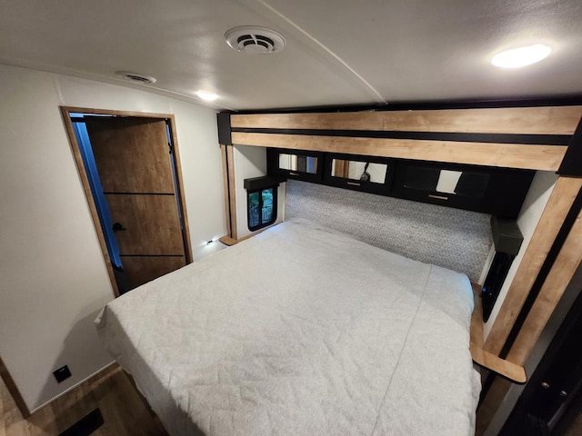 bedroom featuring visible vents and baseboards