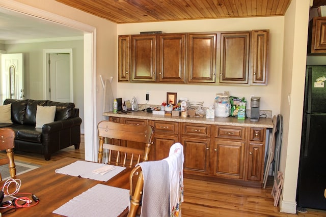 64 Cloe Moore Dr, Murphy, NC 28906 - kitchen with freestanding refrigerator, ornamental molding, light wood-style floors, light countertops, and brown cabinets