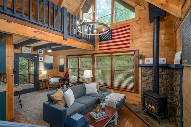 121 Farmstead Rd, Ellijay, GA 30540 - living room with beamed ceiling, hardwood / wood-style flooring, wood walls, and a wood stove