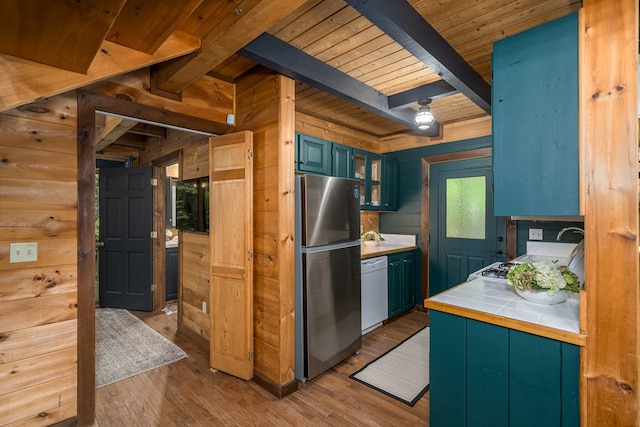 121 Farmstead Rd, Ellijay, GA 30540 - kitchen with freestanding refrigerator, wood walls, white dishwasher, tile counters, and wood ceiling