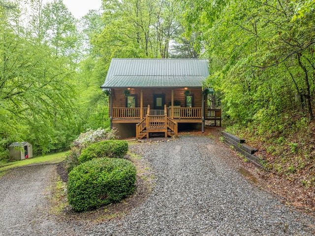 121 Farmstead Rd, Ellijay, GA 30540 - rustic home with covered porch, a shed, stairs, metal roof, and an outbuilding