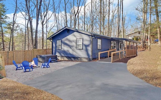 view of side of property featuring a hot tub