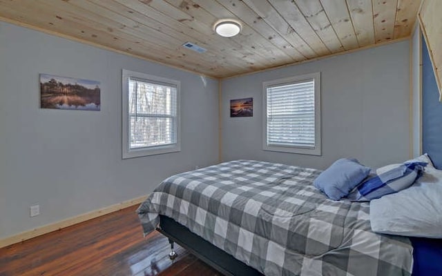 bedroom with wooden ceiling, dark hardwood / wood-style flooring, and crown molding