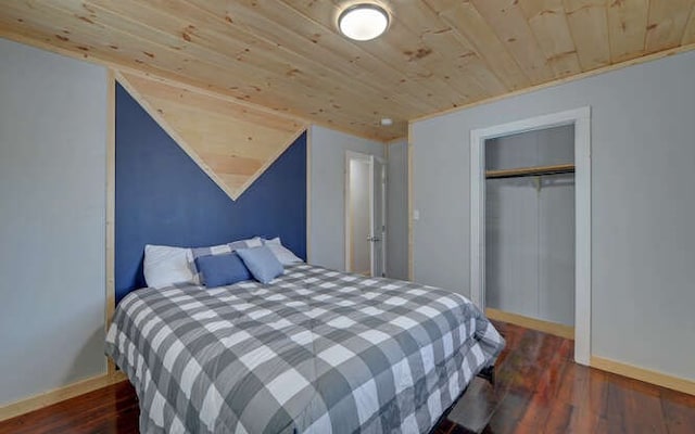 bedroom featuring lofted ceiling, wooden ceiling, a closet, and dark hardwood / wood-style floors