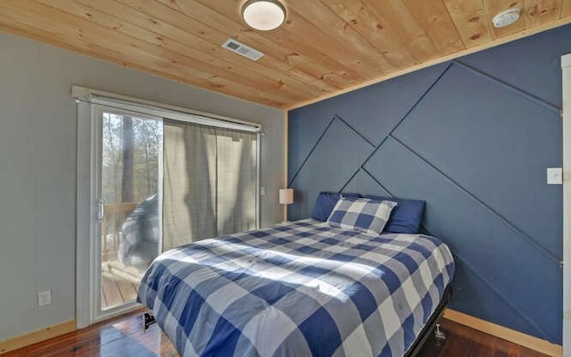 bedroom with dark wood-type flooring and wood ceiling