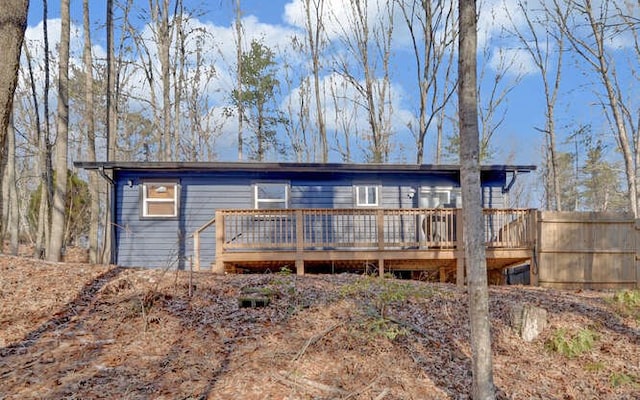 back of property with a wooden deck