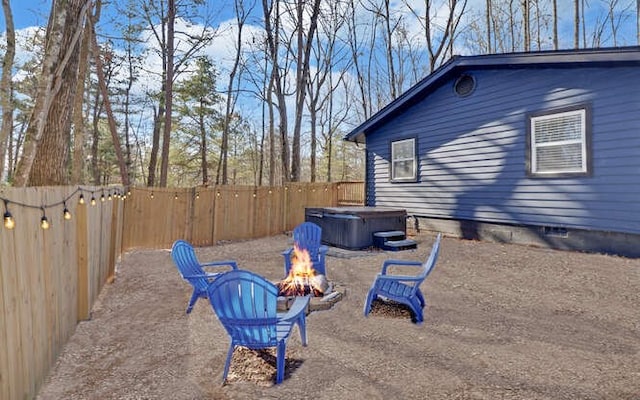 view of yard with an outdoor fire pit and a hot tub