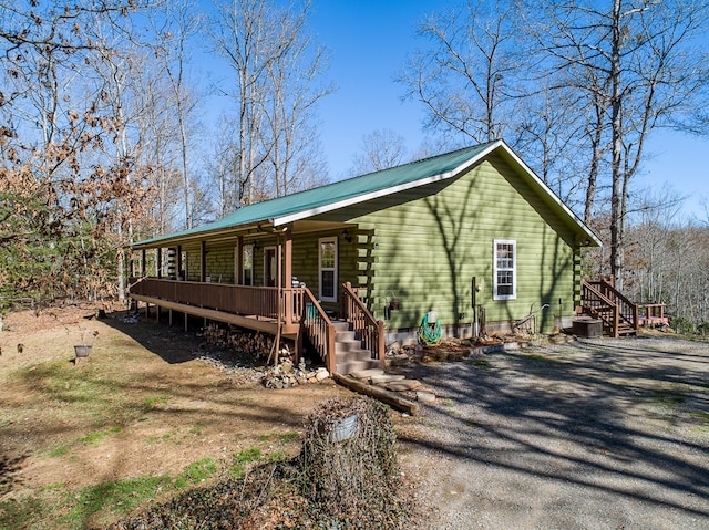 cabin with a deck and central AC unit