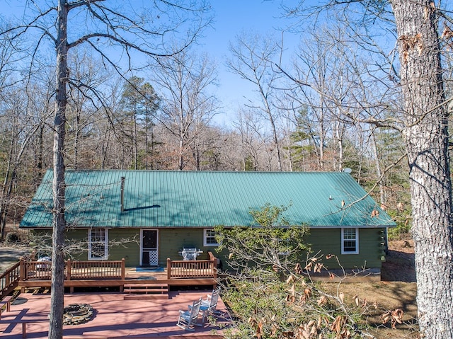 rear view of house featuring a wooden deck