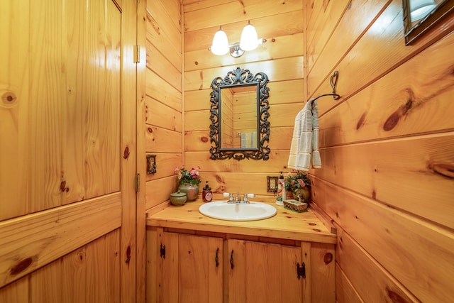 bathroom featuring wooden walls and vanity