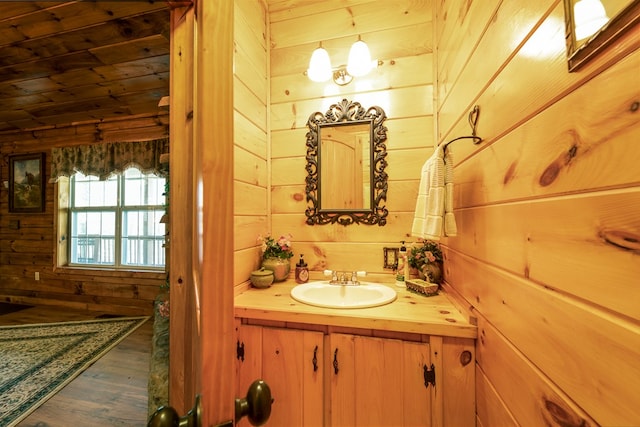 bathroom with wood walls, wood ceiling, hardwood / wood-style floors, and vanity