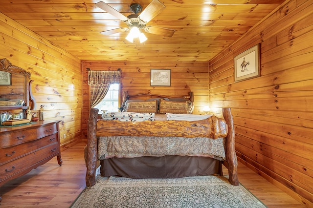 bedroom with wood walls, wood ceiling, light hardwood / wood-style flooring, and ceiling fan