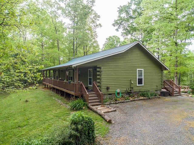 view of front of home with a front yard and a deck