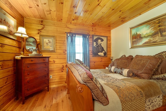 bedroom featuring wooden walls, wooden ceiling, and light hardwood / wood-style floors