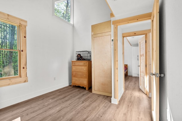 interior space with baseboards and light wood-style floors