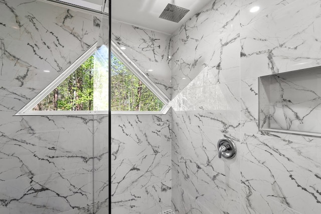 bathroom with a marble finish shower