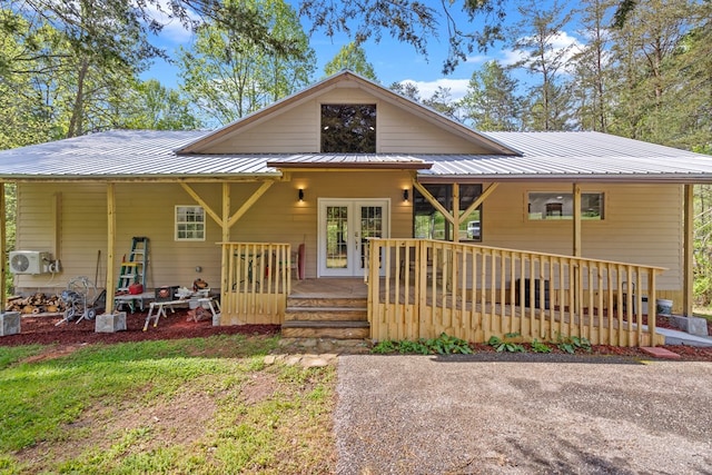 view of front of property with ac unit, metal roof, and a deck