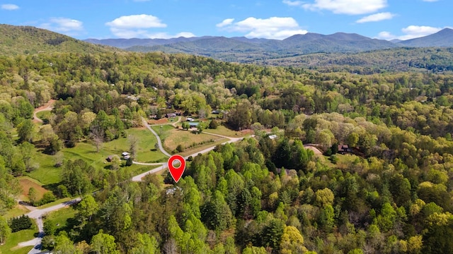 aerial view featuring a view of trees and a mountain view