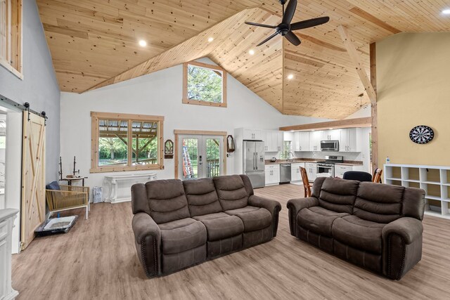 living room featuring a barn door, wooden ceiling, light wood-style flooring, high vaulted ceiling, and ceiling fan
