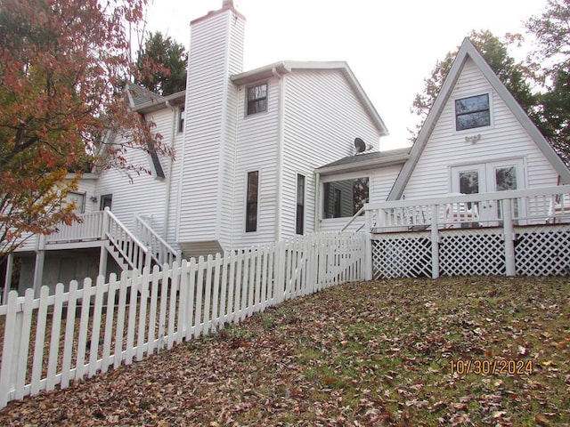 rear view of property featuring a deck