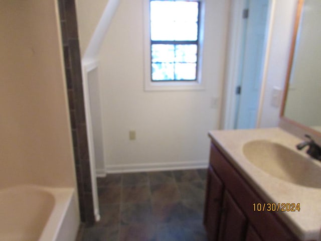 bathroom with vanity and a bath