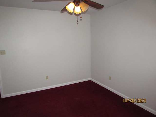 carpeted spare room featuring ceiling fan