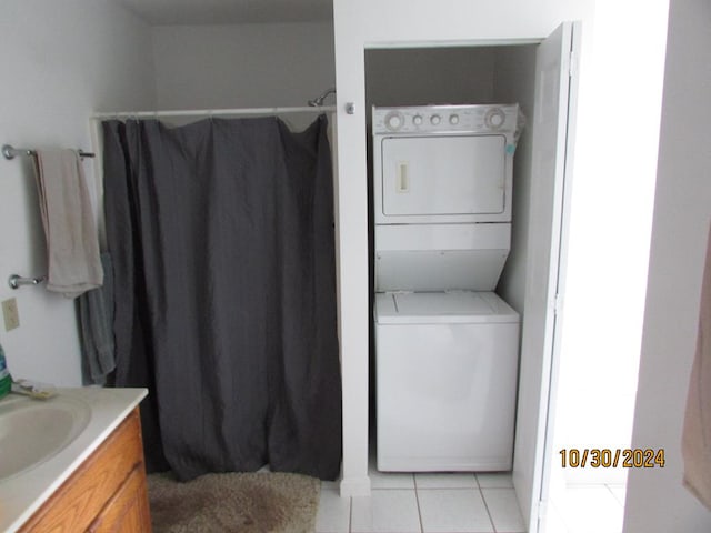 bathroom featuring vanity, tile patterned flooring, toilet, and stacked washing maching and dryer