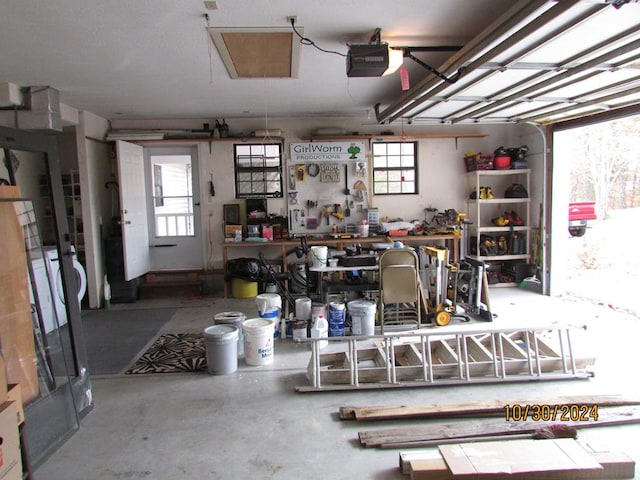 garage featuring a garage door opener and a workshop area