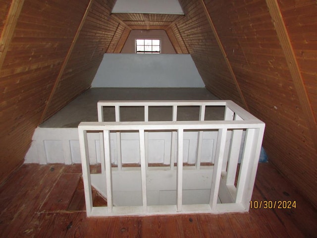 additional living space featuring hardwood / wood-style flooring and vaulted ceiling