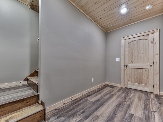 foyer entrance with hardwood / wood-style floors and wood ceiling