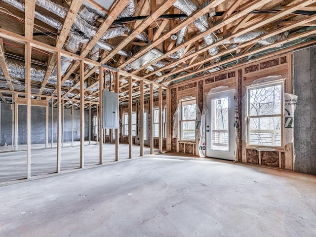 misc room featuring electric panel and concrete floors