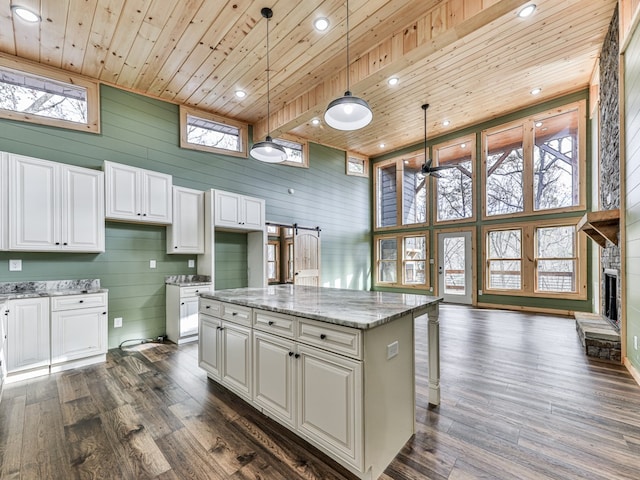 kitchen featuring white cabinetry, dark wood-type flooring, wooden ceiling, and decorative light fixtures