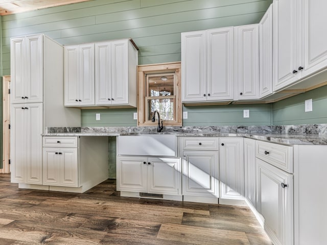 clothes washing area with dark hardwood / wood-style flooring, wood ceiling, wooden walls, and sink