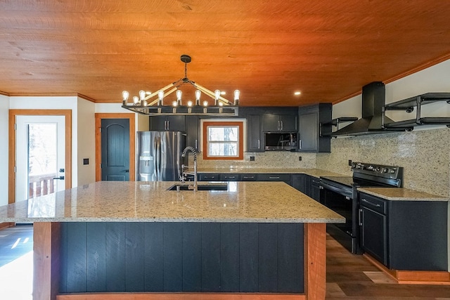 kitchen with appliances with stainless steel finishes, sink, pendant lighting, a center island with sink, and range hood