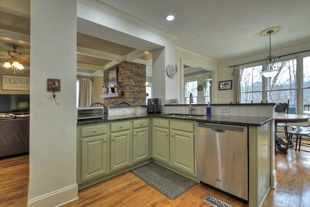 kitchen featuring pendant lighting, kitchen peninsula, dishwasher, sink, and green cabinetry