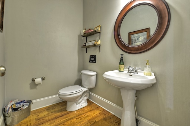 bathroom featuring hardwood / wood-style flooring and toilet