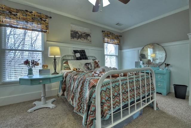 bedroom featuring multiple windows, carpet floors, ornamental molding, and ceiling fan